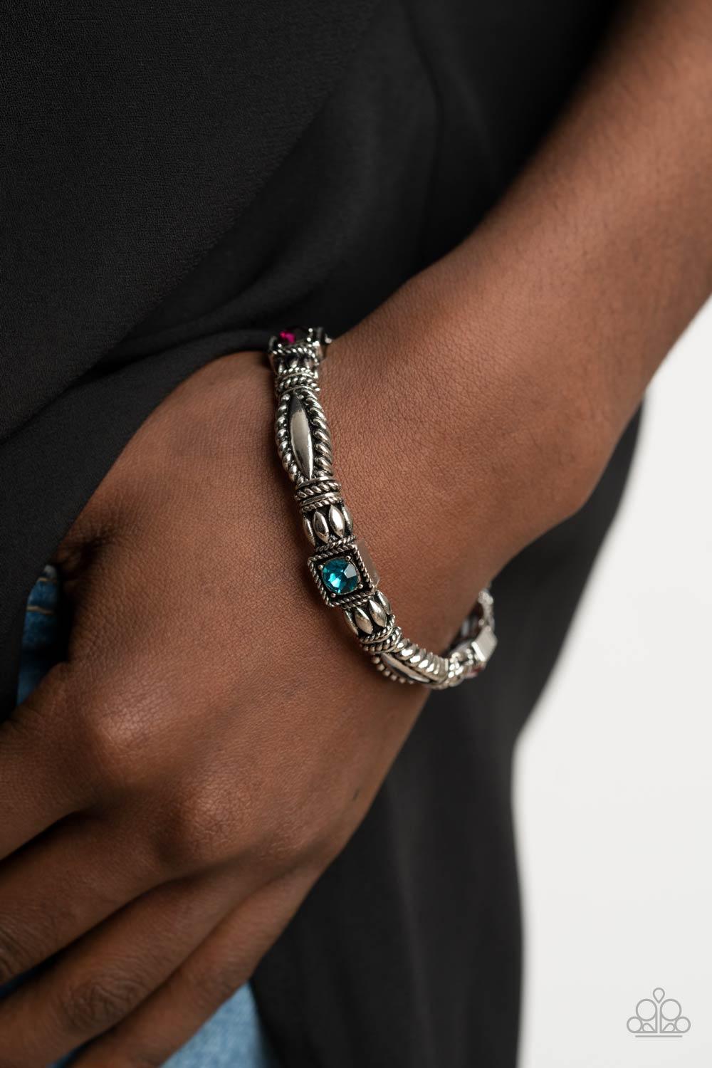 Paparazzi Accessories Get This GLOW On The Road - Multi Dotted with green, purple, blue, and pink rhinestone centers, decorative silver frames are threaded along stretchy bands around the wrist, creating a colorful display. Sold as one individual bracelet