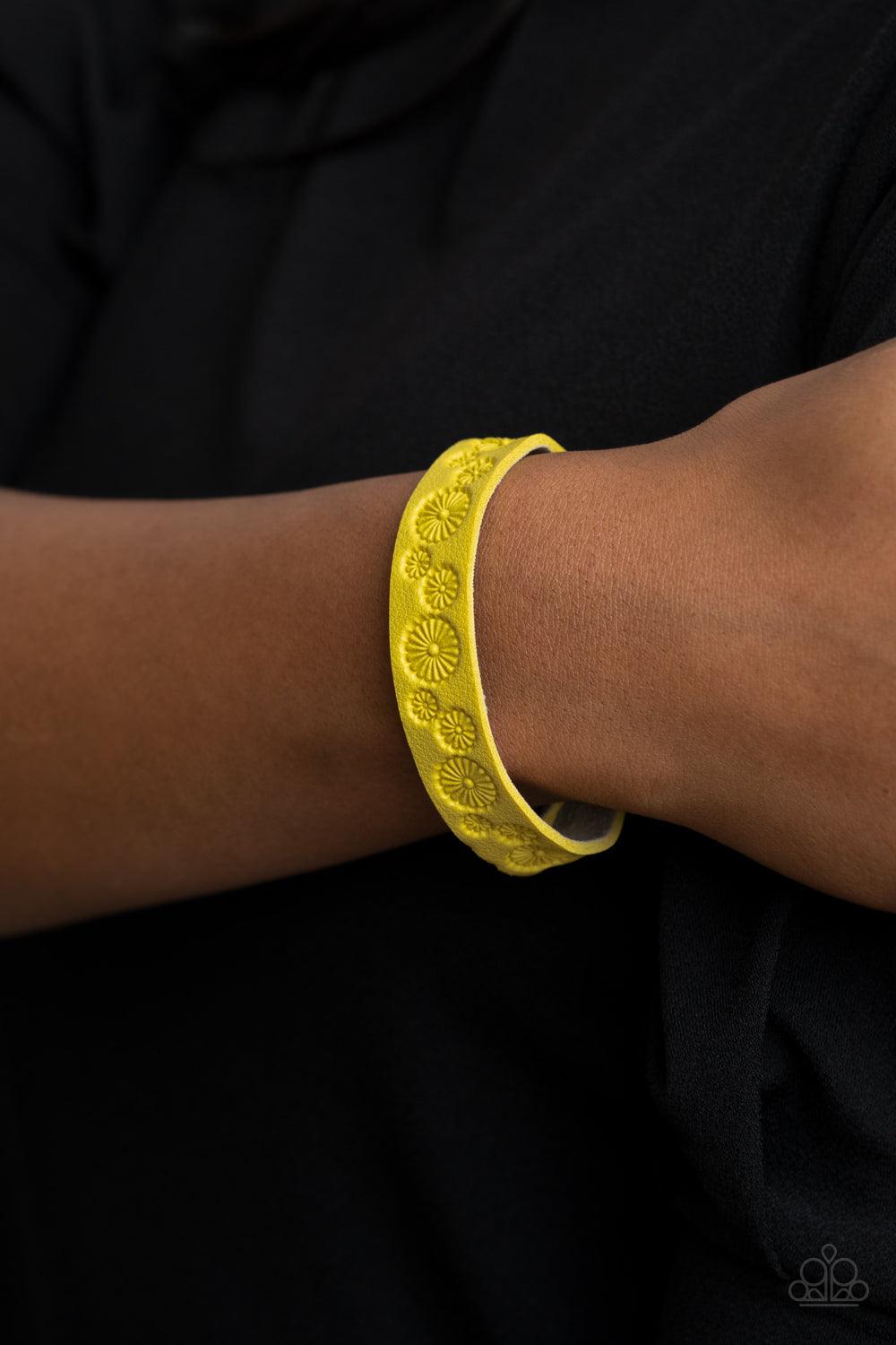 Paparazzi Accessories Follow The Wildflowers - Yellow Stamped in a whimsical daisy pattern, a dainty Illuminating leather band wraps around the wrist for a seasonal flair. Features an adjustable snap closure. Sold as one individual bracelet. Jewelry