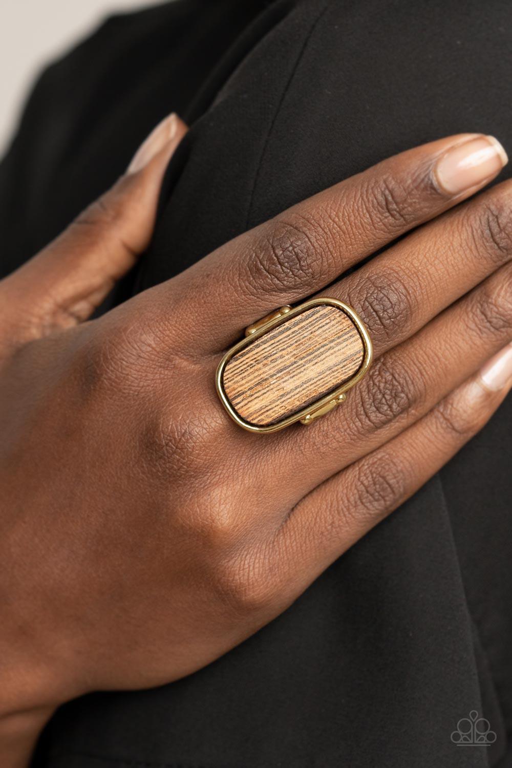 Paparazzi Accessories Reclaimed Refinement - Gold Encased in a sleek gold frame, a rustic piece of wood sits atop the finger for an unexpected refinement. Features a stretchy band for a flexible fit. Sold as one individual ring. Jewelry