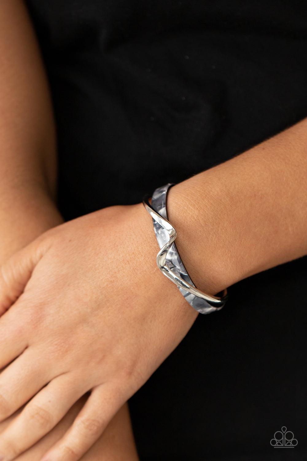 Paparazzi Accessories Craveable Curves - Silver A flat silver bar delicately curls across a dainty gray shell-like acrylic cuff, creating a whimsical centerpiece around the wrist. Sold as one individual bracelet. Jewelry