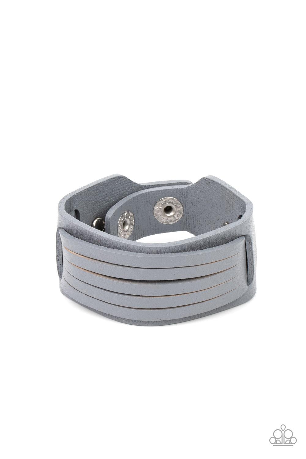 Paparazzi Accessories Ride In Style - Silver Spliced into layers, a gray leather band is threaded through the center of a larger gray leather band and studded in place for a rustic finish. Features an adjustable snap closure. Sold as one individual bracel