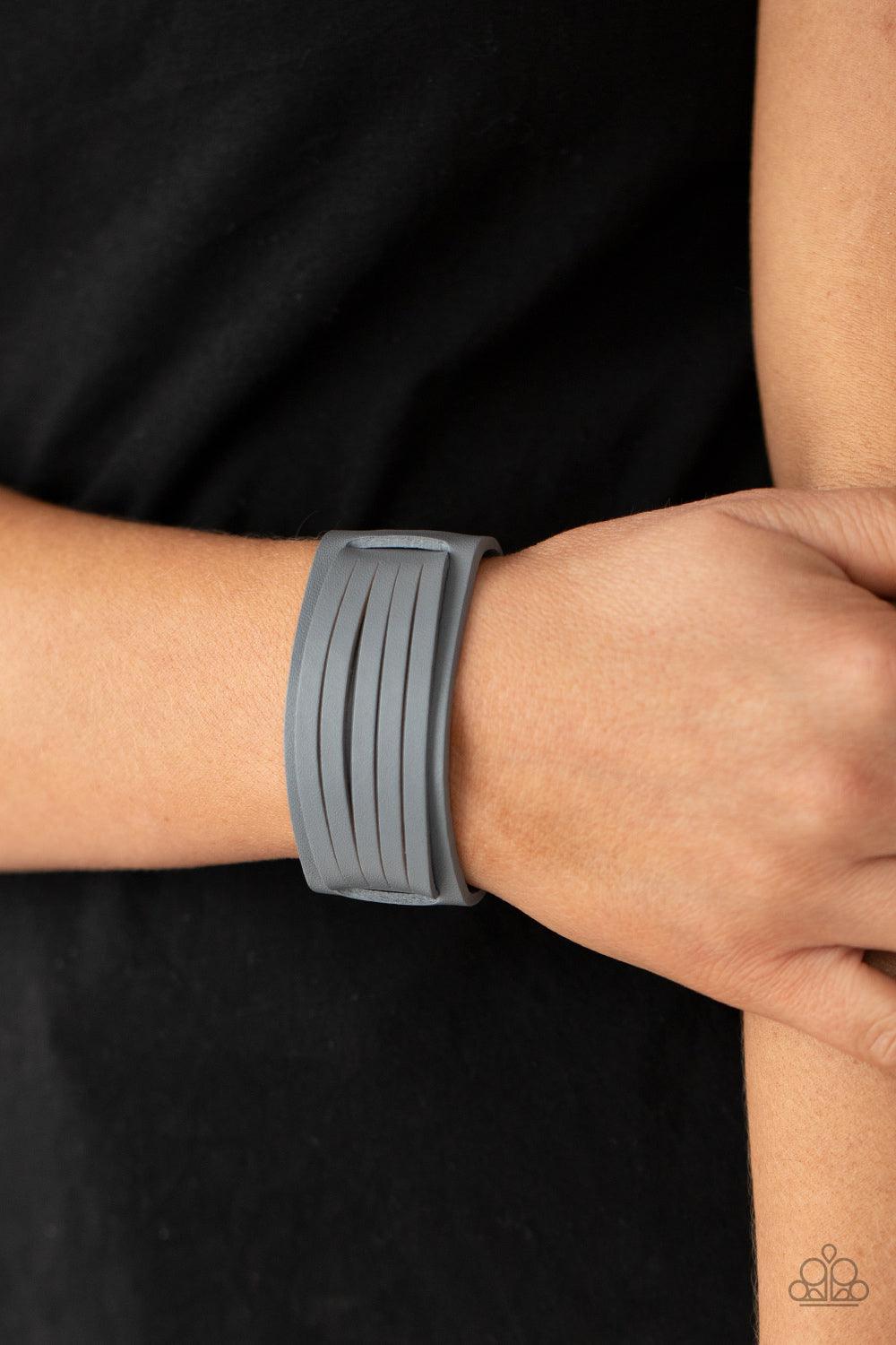 Paparazzi Accessories Ride In Style - Silver Spliced into layers, a gray leather band is threaded through the center of a larger gray leather band and studded in place for a rustic finish. Features an adjustable snap closure. Sold as one individual bracel