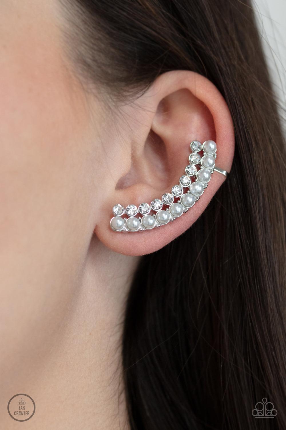 Paparazzi Accessories Doubled Down On Dazzle - White Featuring classic silver fittings, two rows of dainty white pearls and glassy white rhinestones arch into a timeless statement piece. Earring attaches to a standard post earring. Features a clip-on fitt