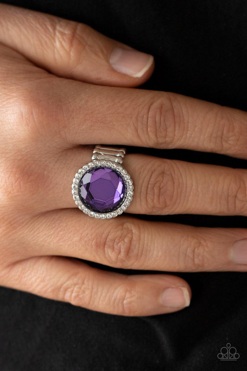 Paparazzi Accessories Crown Culture - Purple A round purple gem is bordered in a glassy ring of dainty white rhinestones, creating a sparkly centerpiece atop the finger. Features a stretchy band for a flexible fit. Sold as one individual ring. Jewelry