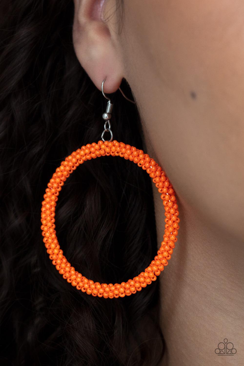 Paparazzi Accessories Beauty and the BEACH - Orange A dainty strand of neon orange seed beads wrap around a silver hoop, creating a bubbly hoop. Earring attaches to a standard fishhook fitting. Sold as one pair of earrings. Earrings
