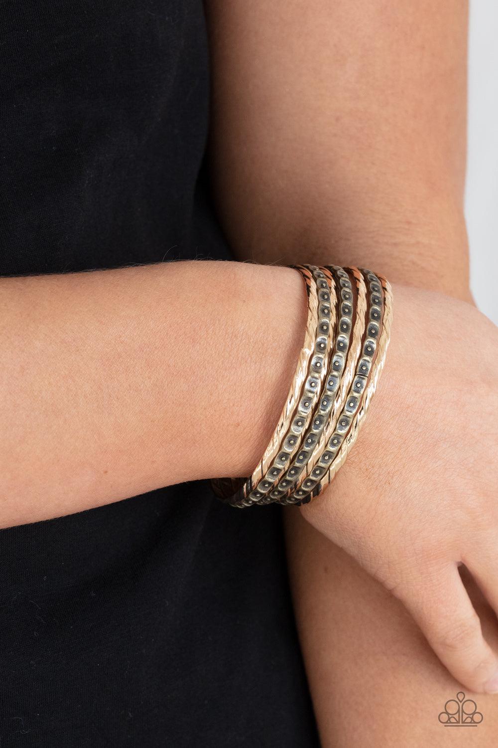 Paparazzi Accessories Back-To-Back Stacks - Multi Embossed in slanted ribbons of textured and studded hammered patterns, trios of mismatched brass and gold bangles stack across the wrist for an intense industrial vibe. Sold as one set of six bracelets. Je
