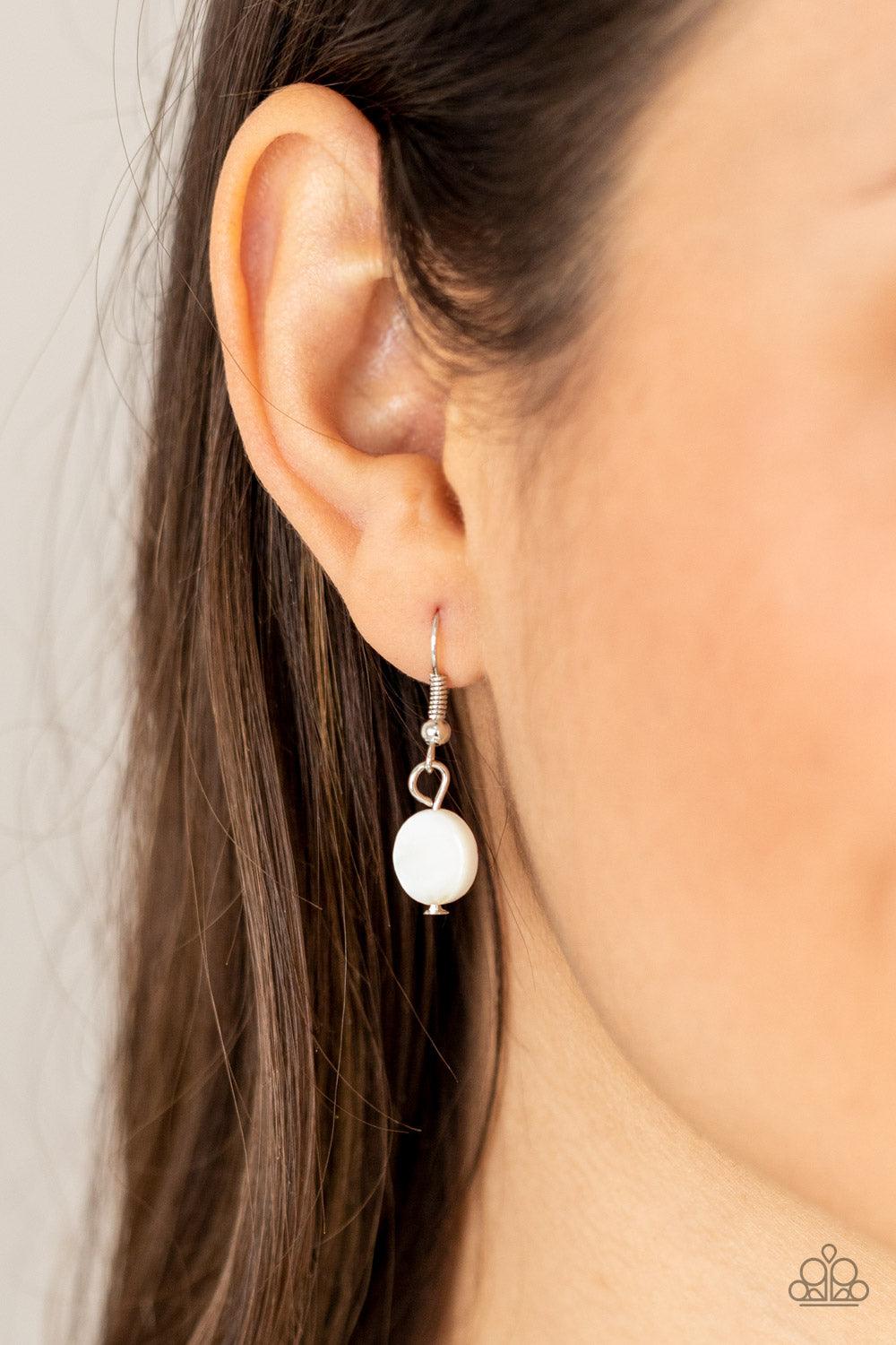 Paparazzi Accessories Extended STAYCATION - Blue A summery collection of shiny white shell-like discs and dainty blue beads are threaded along invisible wire, creating colorful layers below the collar. Features an adjustable clasp closure. Sold as one ind