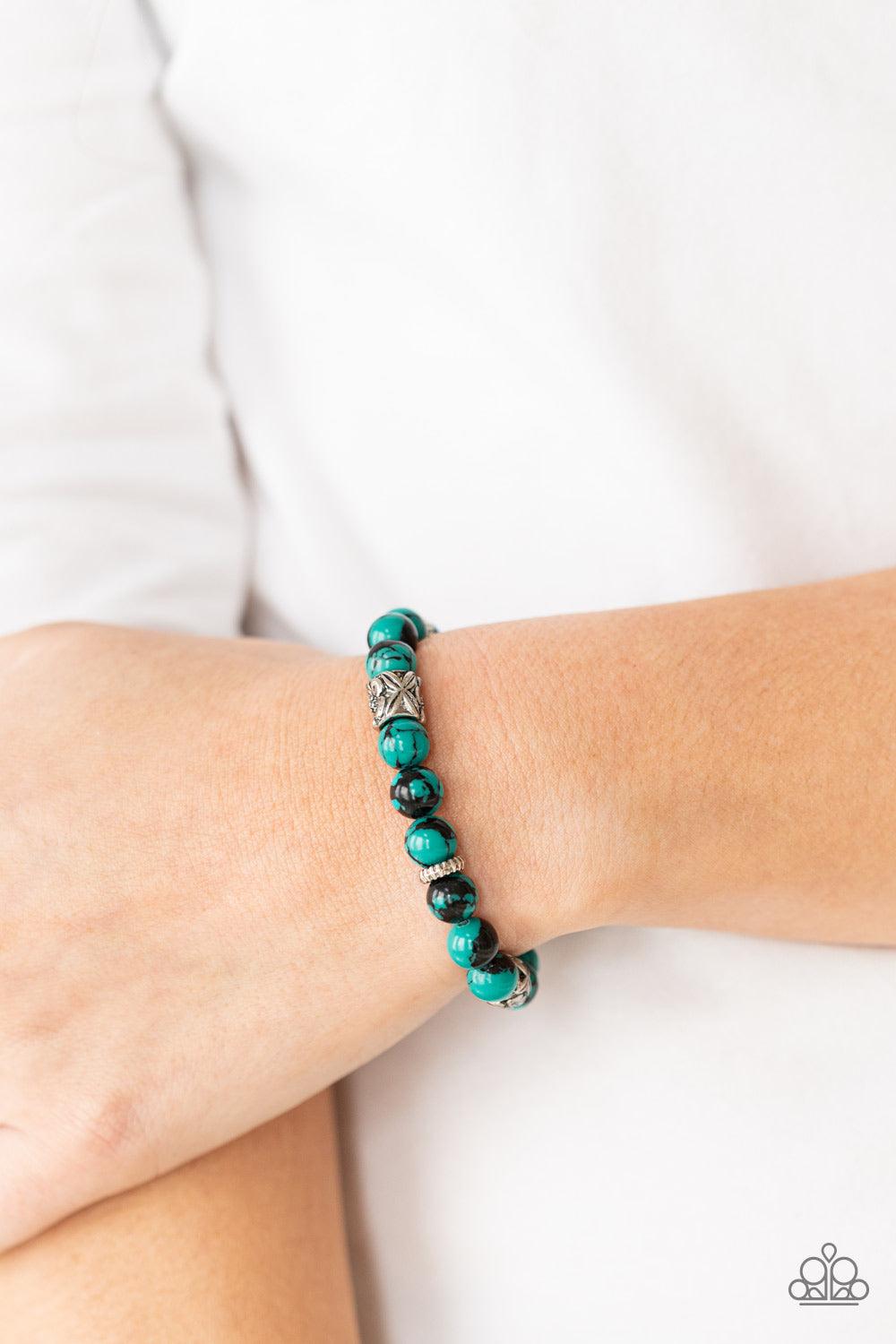 Paparazzi Accessories Garden Zen - Green An earthy collection of glassy green and black beads, textured silver rings, and floral embossed beads are threaded along stretchy bands around the wrist, creating a seasonal centerpiece. Sold as one individual bra