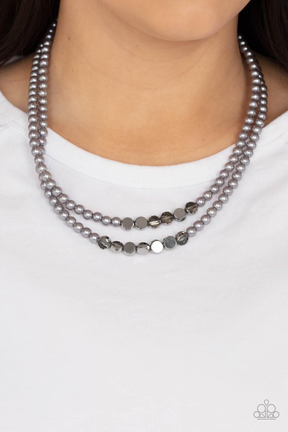 Paparazzi Accessories Poshly Petite - Silver A posh collection of pearly gray beads, accented by sections of flat, faceted metallic beads, is threaded along invisible wires, creating sophisticated layers that fall below the collar. Features an adjustable