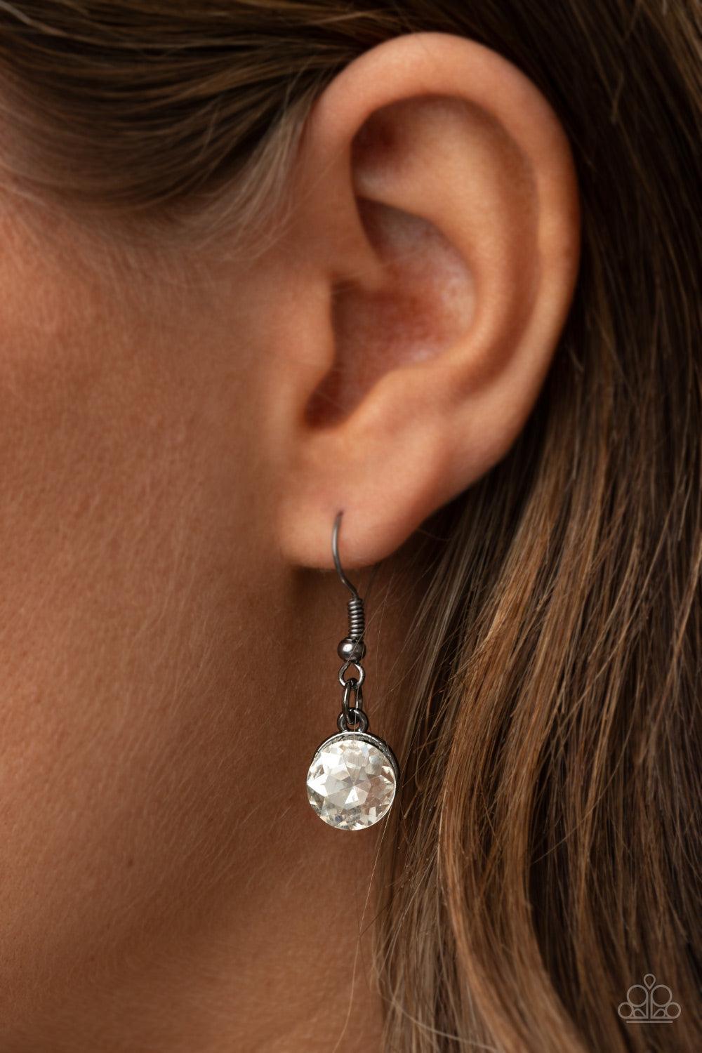 Paparazzi Accessories Galactic Goddess - Black An unexpected explosion of oversized round, teardrop, and emerald cut rhinestones cluster into haphazard groupings. The blinding clusters link together, creating a stellar statement piece that sits below the