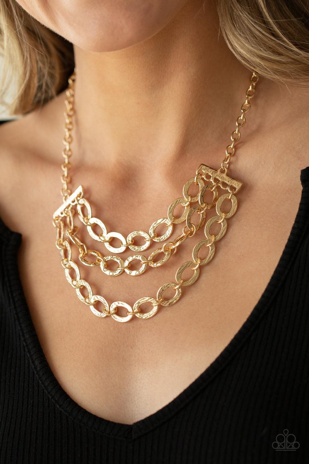 Paparazzi Accessories Repeat After Me - Gold Three rows of gold chains with oversized hammered oval links attach to gold bars for an edgy display below the collar. Features an adjustable clasp closure. Sold as one individual necklace. Includes one pair of