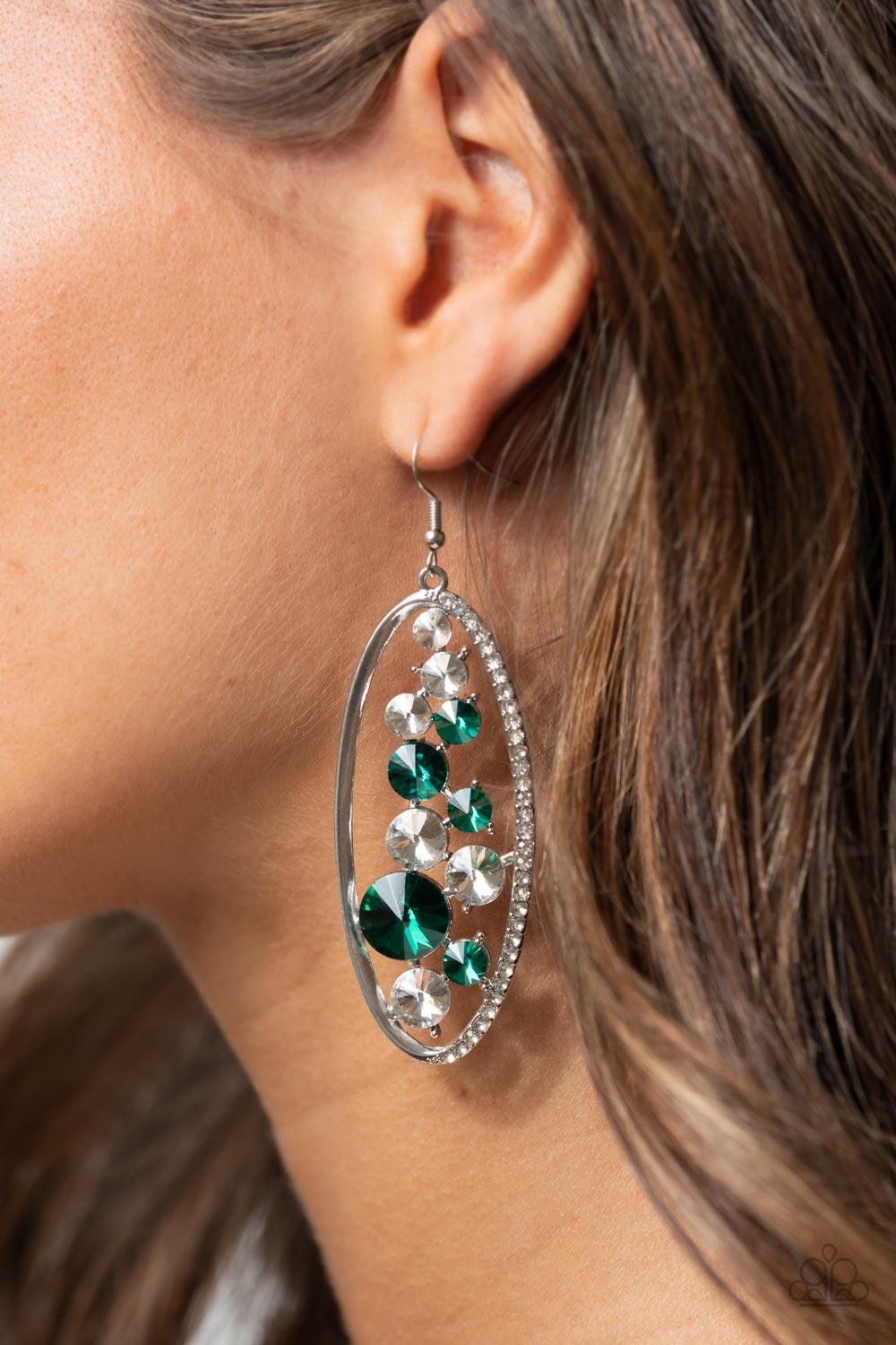Paparazzi Accessories Rock Candy Bubbly - Green An oversized collection of glassy white and glittery green rhinestones sparkle inside a silver oval frame. One side of the frame is encrusted in dainty white rhinestones, adding a refined flair to the bubbly