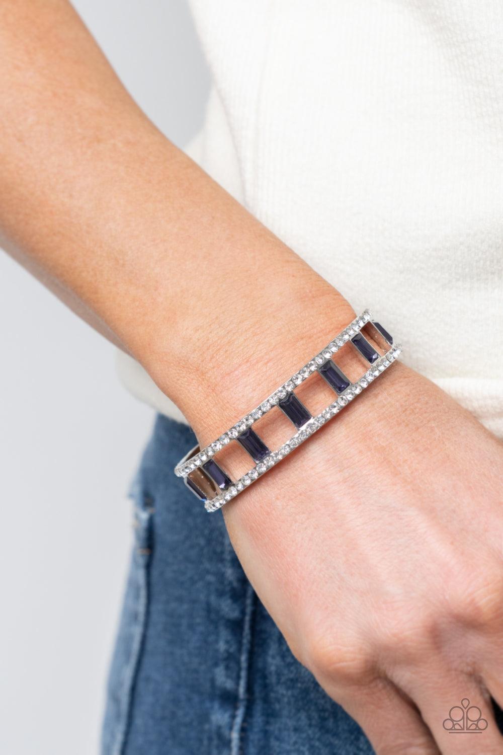 Paparazzi Accessories Industrial Icing - Purple Bands of glittery white rhinestones overlaid on silver frames create an airy channel-like framework. Elegant baguette style cut purple gems, connected to the glittery framework, circle around the wrist for a