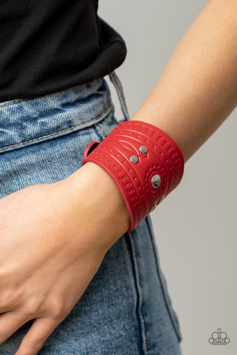 Paparazzi Accessories Orange County - Red Dotted in shiny silver studs, a triangular piece of red leather is stamped in indigenous inspired patterns for an urban flair. Features an adjustable snap closure. Sold as one individual bracelet.2.77 Bracelets