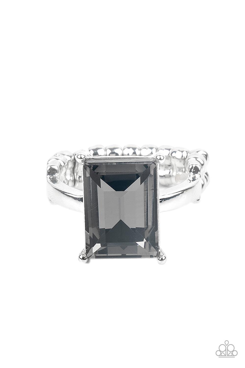 Paparazzi Accessories Social Glow - Silver A smoky emerald cut gem is nestled inside a pronged silver frame atop a dainty silver band, creating a sparkly statement atop the finger. Features a dainty stretchy band for a flexible fit. Sold as one individual