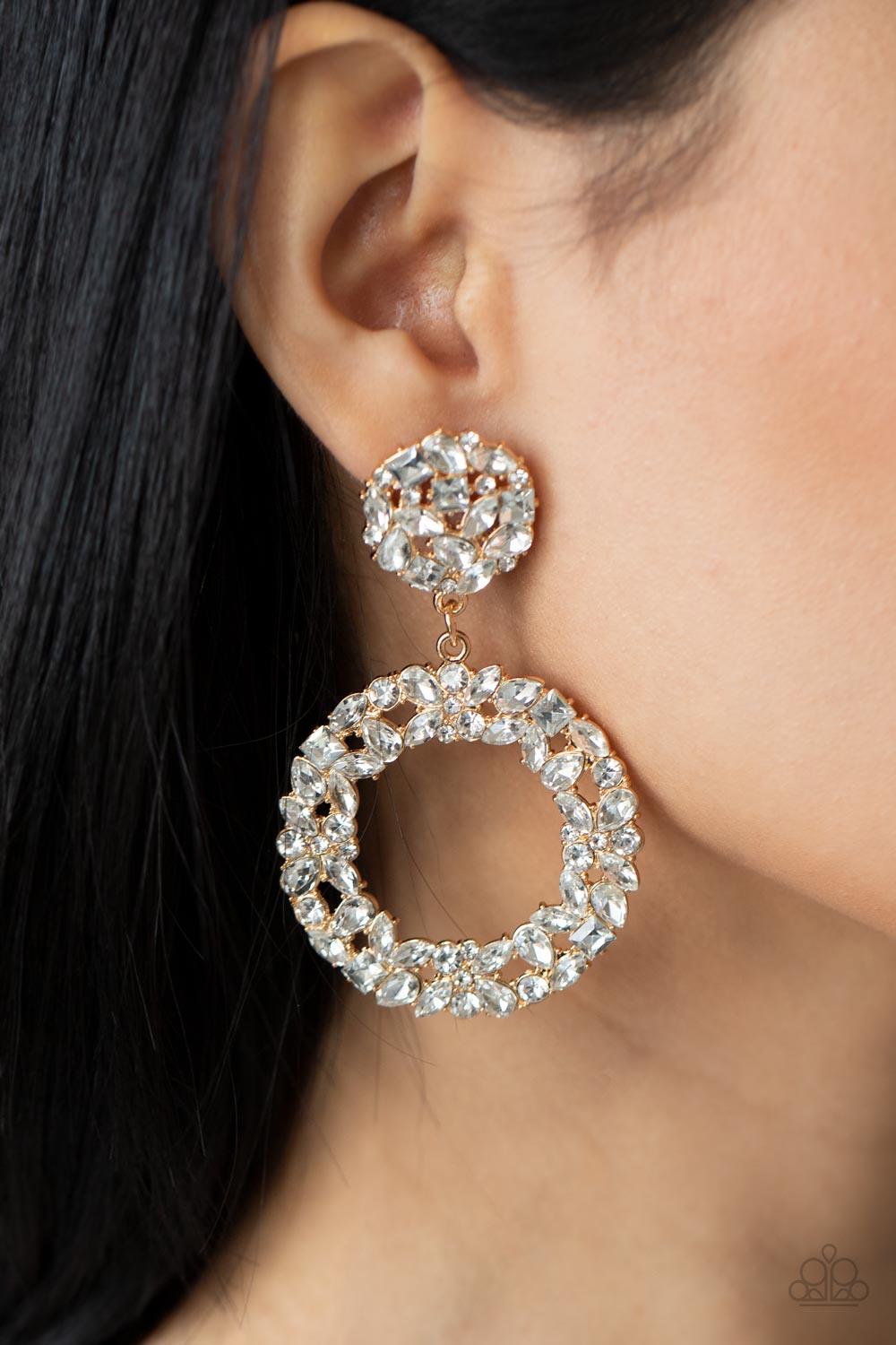 Paparazzi Accessories Party Ensemble - Gold A sparkly wreath of marquise, square, teardrop, and classic white rhinestones delicately swings from the bottom of a matching round golden frame, creating a dramatically dazzling statement piece. Earring attache