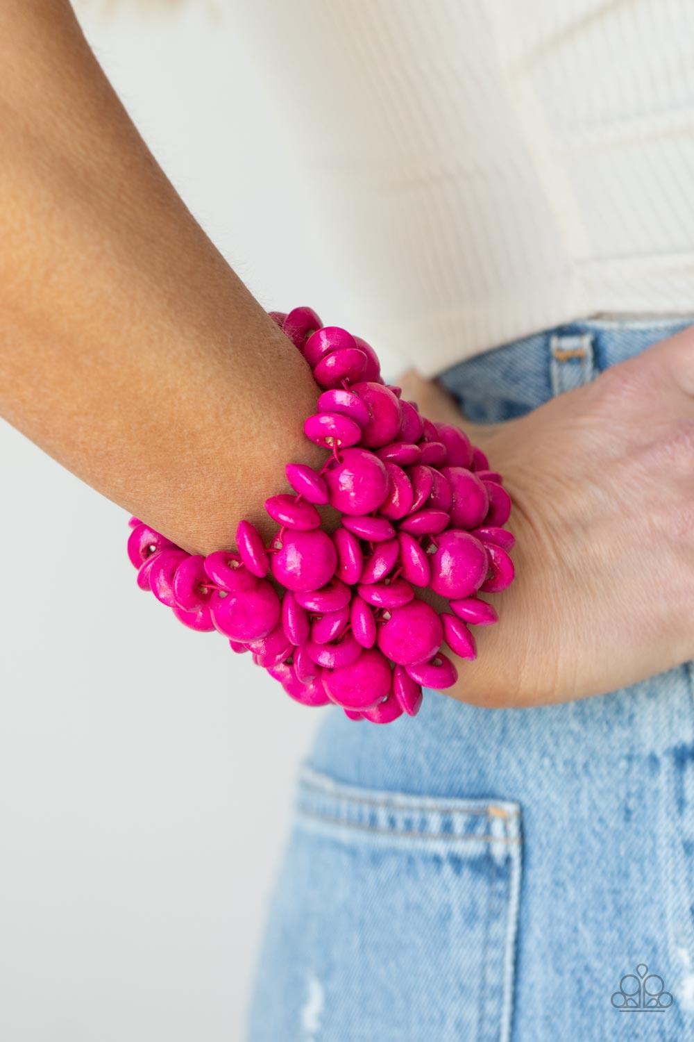 Paparazzi Accessories Island Mixer - Pink Brushed in a vibrant pink finish, an oversized collection of disc shaped and round wooden beads are threaded along ornately knotted woven stretchy bands around the wrist for a tropical inspired fashion. Sold as on
