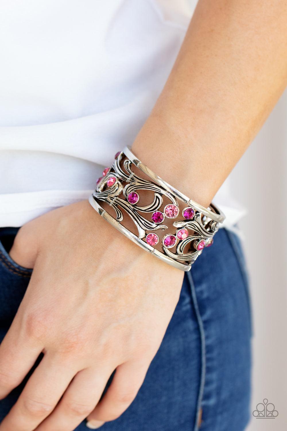 Paparazzi Accessories Garden Masquerade - Pink An ombre of pink rhinestones scatters across an airy floral frame among vine-like filigree. The romantically whimsical frames are threaded along stretchy bands and repeat around the wrist for an enchanting di