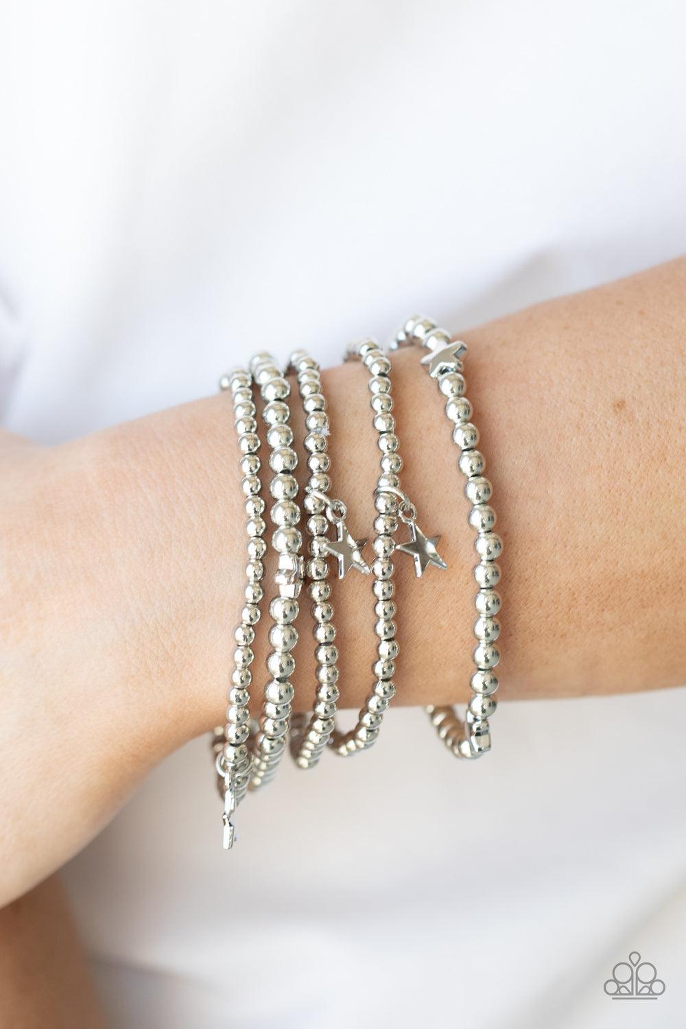Paparazzi Accessories American All-Star - Silver Infused with dainty silver star beads and shiny silver star charms, strands of silver beaded stretchy bands stack across the wrist, creating a patriotic shimmer. Sold as one individual bracelet. Jewelry