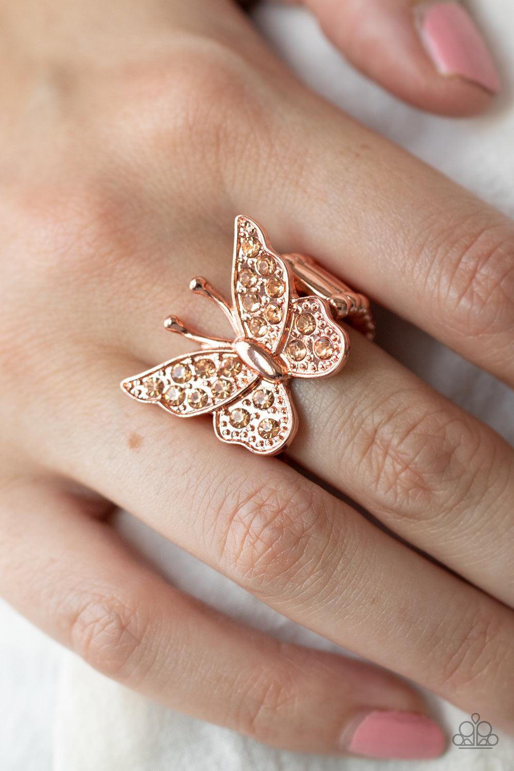 Paparazzi Accessories Bona Fide Butterfly - Copper Encrusted in sparkly rhinestones, a shiny copper butterfly flutters atop the finger for an enchanting fashion. Features a stretchy band for a flexible fit. Sold as one individual ring. Jewelry