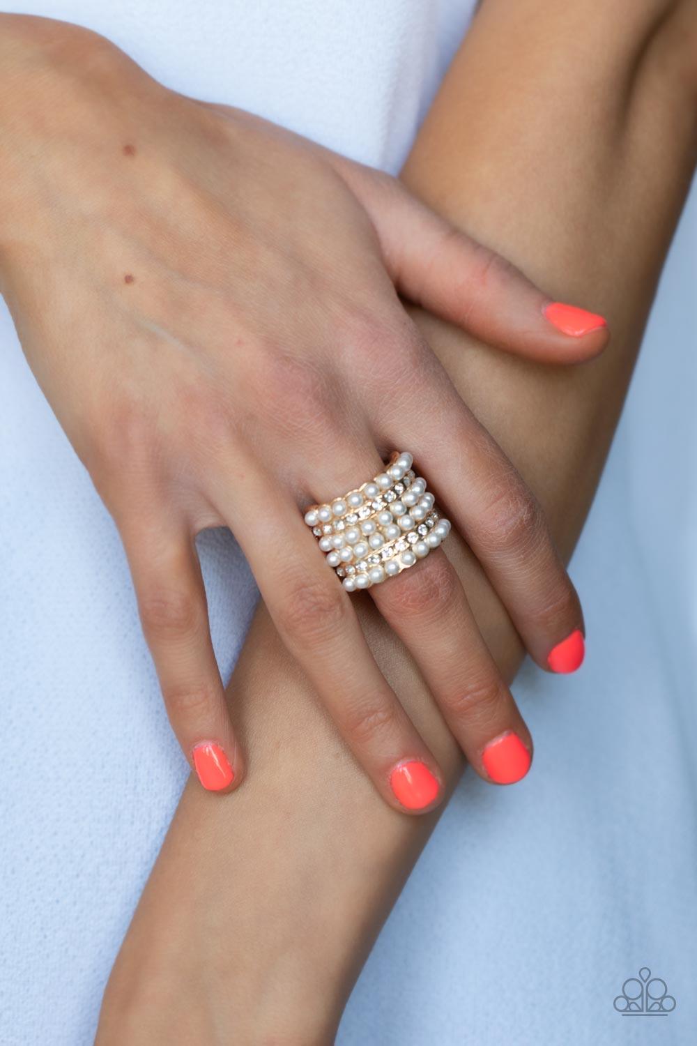Paparazzi Accessories Verified Vintage - Gold Dainty rows of bubbly pearls and glassy white rhinestones alternate across the front of a thick gold band, creating a vintage inspired statement piece. Features a stretchy band for a flexible fit. Sold as one