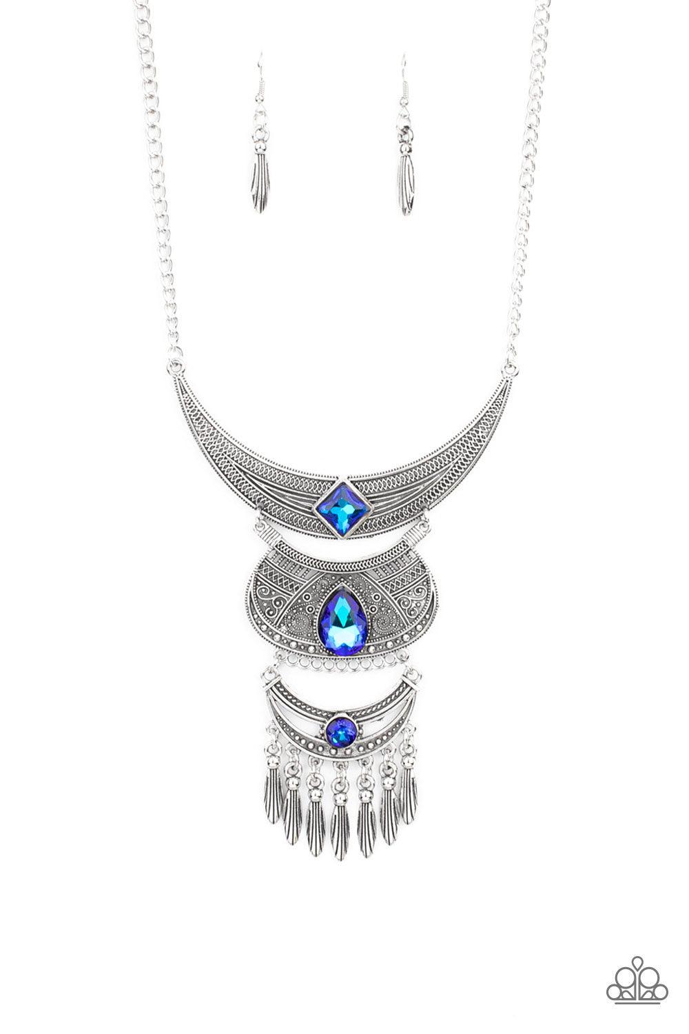 Paparazzi Accessories Lunar Enchantment - Blue Embossed in studded, geometric, and paisley filigree-like patterns, three mismatched silver half moon plates dramatically link below the collar. Featuring an entrancing blue UV shimmer, an oversized collectio