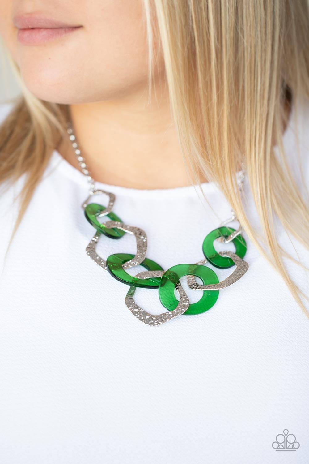 Paparazzi Accessories Urban Circus - Green An asymmetrical assortment of Leprechaun acrylic rings and hammered silver hoops boldly interlock below the collar, creating an intense pop of color. Features an adjustable clasp closure. Sold as one individual n