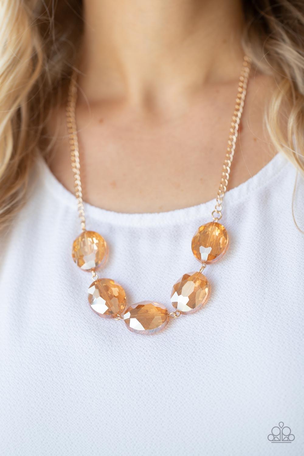 Paparazzi Accessories Cosmic Closeup - Gold Brushed in an iridescent finish, a faceted collection of oversized golden gems delicately links below the collar for a gritty glamorous look. Features an adjustable clasp closure. Sold as one individual necklace