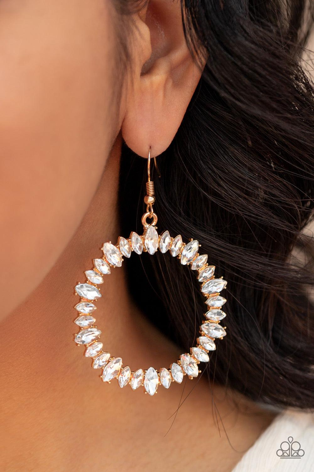 Paparazzi Accessories Glowing Reviews - Gold Encased in gold pronged fittings, an incandescent array of white marquise cut rhinestones delicately coalesce into a glowing hoop. Earring attaches to a standard fishhook fitting. Sold as one pair of earrings.