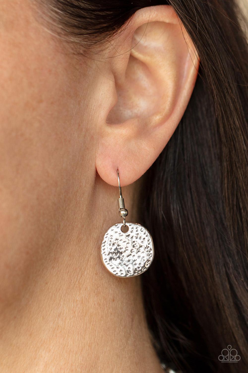 Paparazzi Accessories Spot On Sparkle - White A blinding collection of hammered silver discs and oversized white gems swing from the bottom of a bold silver chain, creating noise-making sparkle below the collar. Features an adjustable clasp closure. Sold