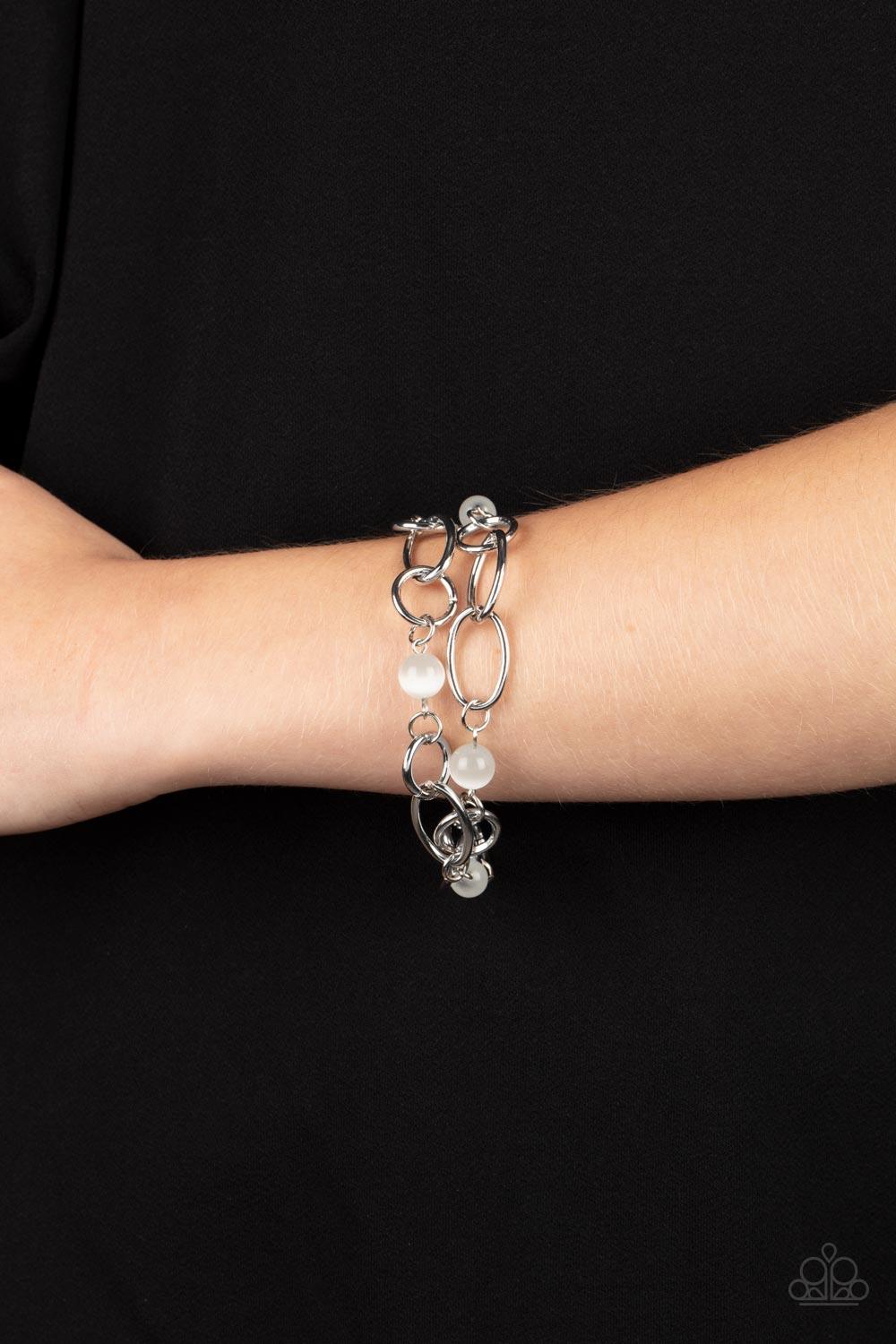 Paparazzi Accessories Delightfully Daydreamy - White Chunky silver links and glassy white cat's eye stone beads join into two dreamy layers around the wrist, creating a whimsical centerpiece. Features an adjustable clasp closure. Sold as one individual br