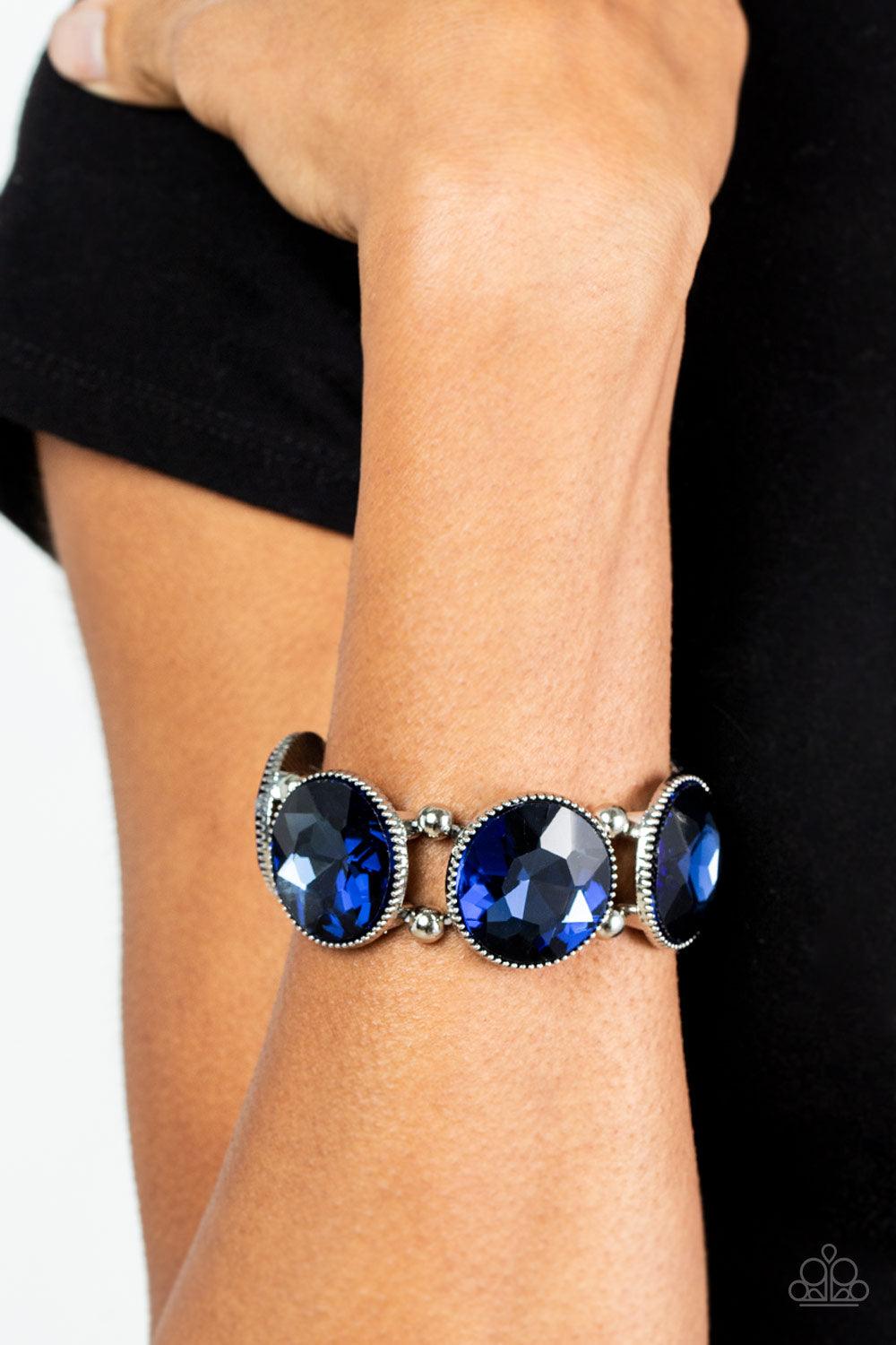 Paparazzi Accessories Powerhouse Hustle - Blue Infused with pairs of silver beads, a glitzy collection of dramatically oversized Rhodonite rhinestone frames are threaded along stretchy bands around the wrist for a jaw-dropping dazzle. Sold as one individu