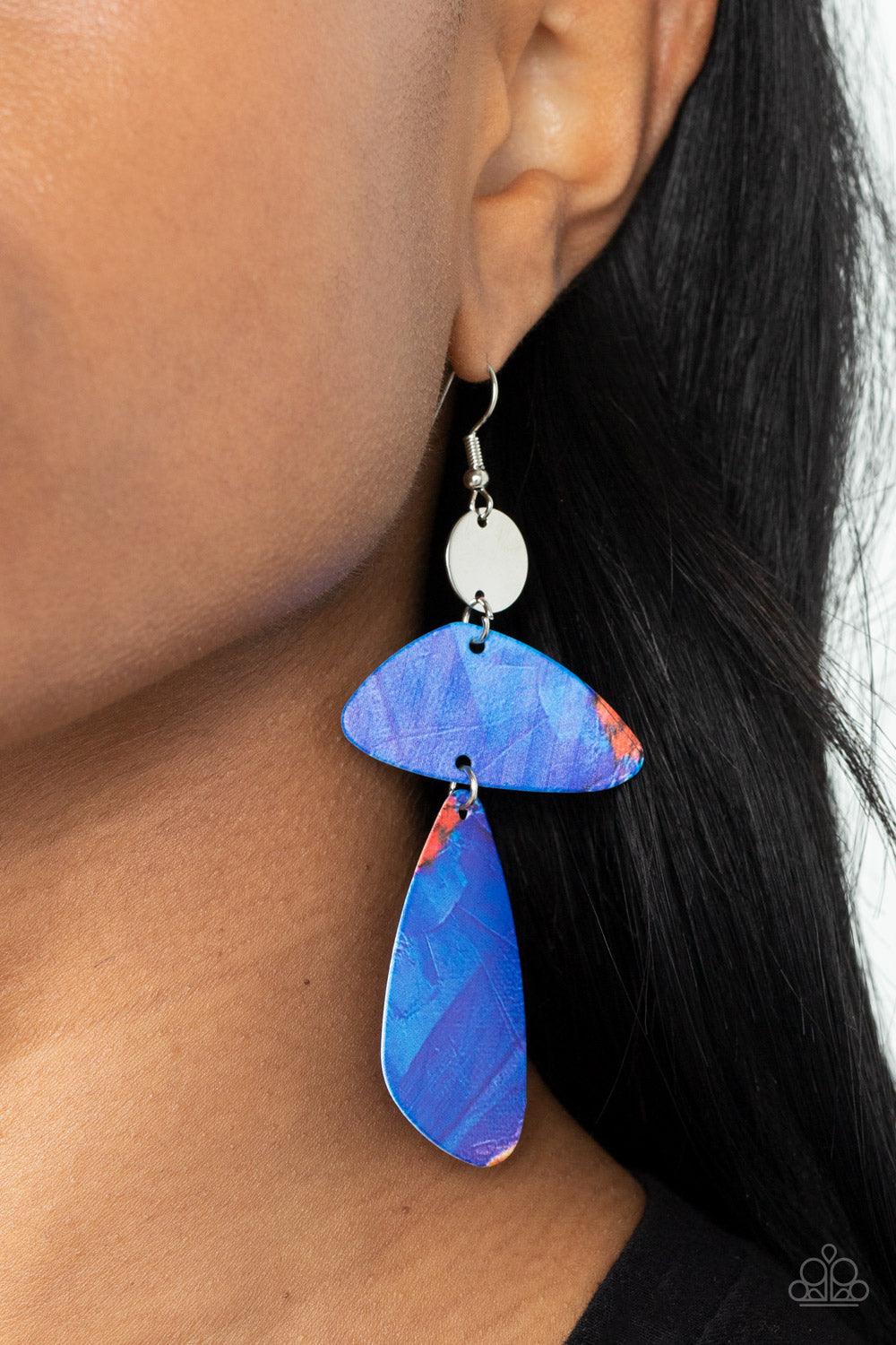 Paparazzi Accessories SWATCH Me Now - Blue Painted in abstract blue details, a pair of asymmetrical frames swing form the bottom of a dainty silver disc for an artsy look. Earring attaches to a standard fishhook fitting. Sold as one pair of earrings. Earr