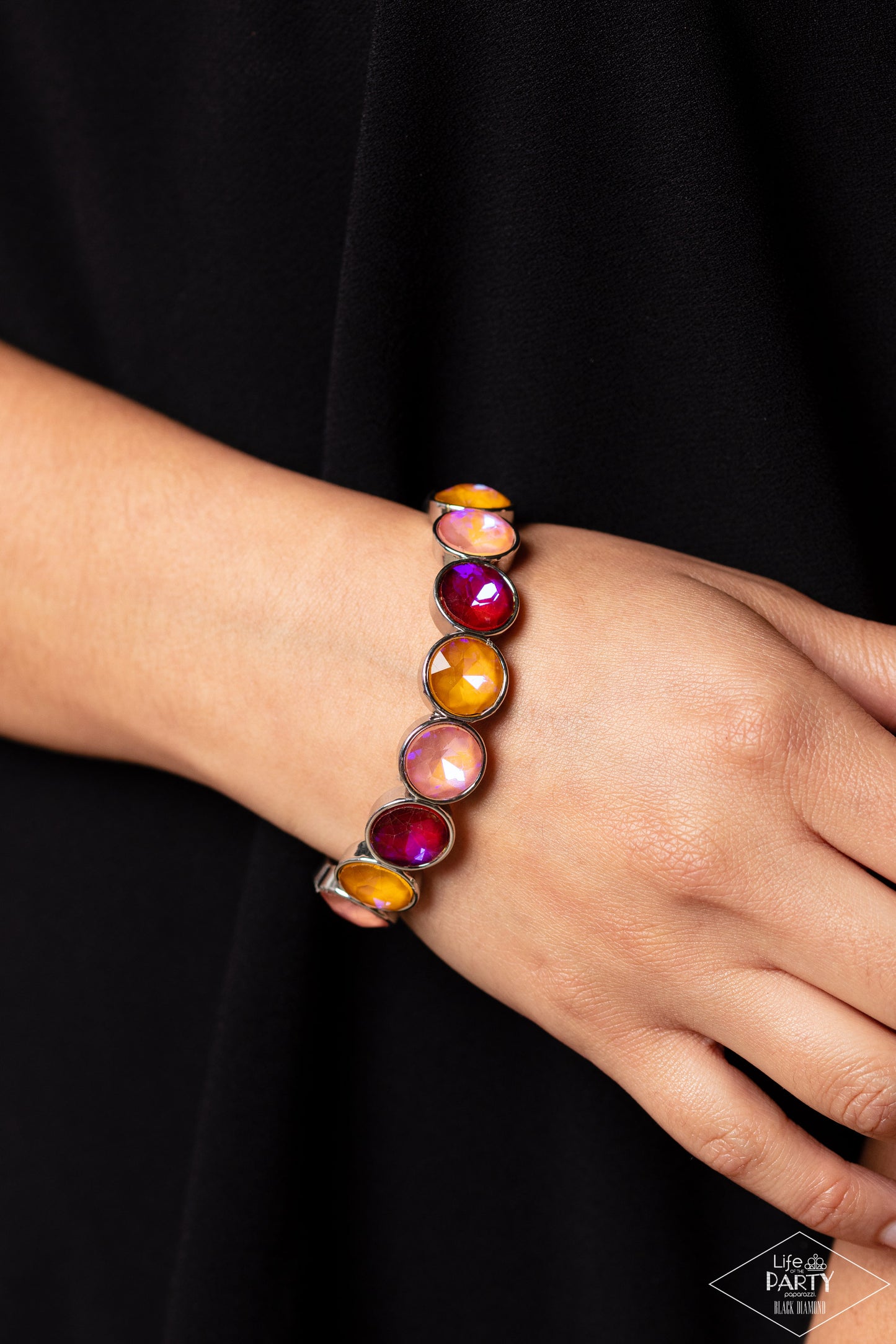 Paparazzi Accessories Radiant on Repeat - Orange Encased in sleek silver fittings, a sparkly series of opalescent orange, yellow, and coral rhinestones are threaded along stretchy bands around the wrist for a radiant finish. Sold as one individual bracele
