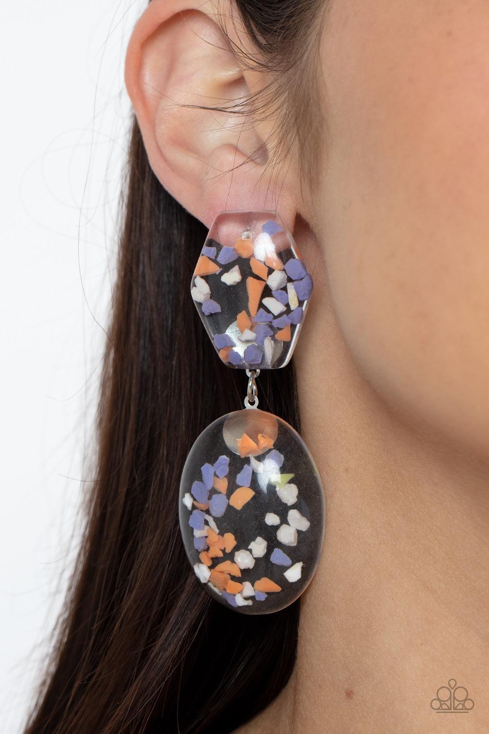 Paparazzi Accessories Flaky Fashion - Orange Featuring multicolored confetti-like flakes, a clear acrylic oval frame swings from the bottom of a matching hexagonal frame, creating a bubbly lure. Earring attaches to a standard post fitting. Sold as one pai