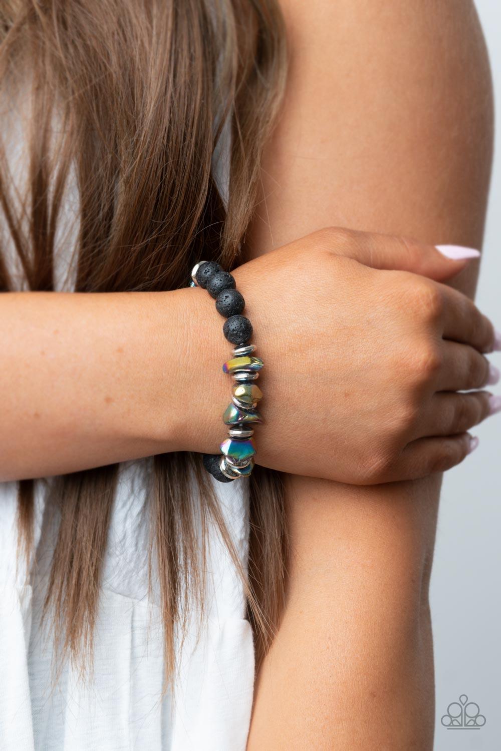 Paparazzi Accessories Volcanic Vacay - Multi An earthy collection of black lava rock beads, dainty silver discs, and oil spill metallic pebbles are threaded along a stretchy band around the wrist, resulting in an edgy look. Sold as one individual bracelet