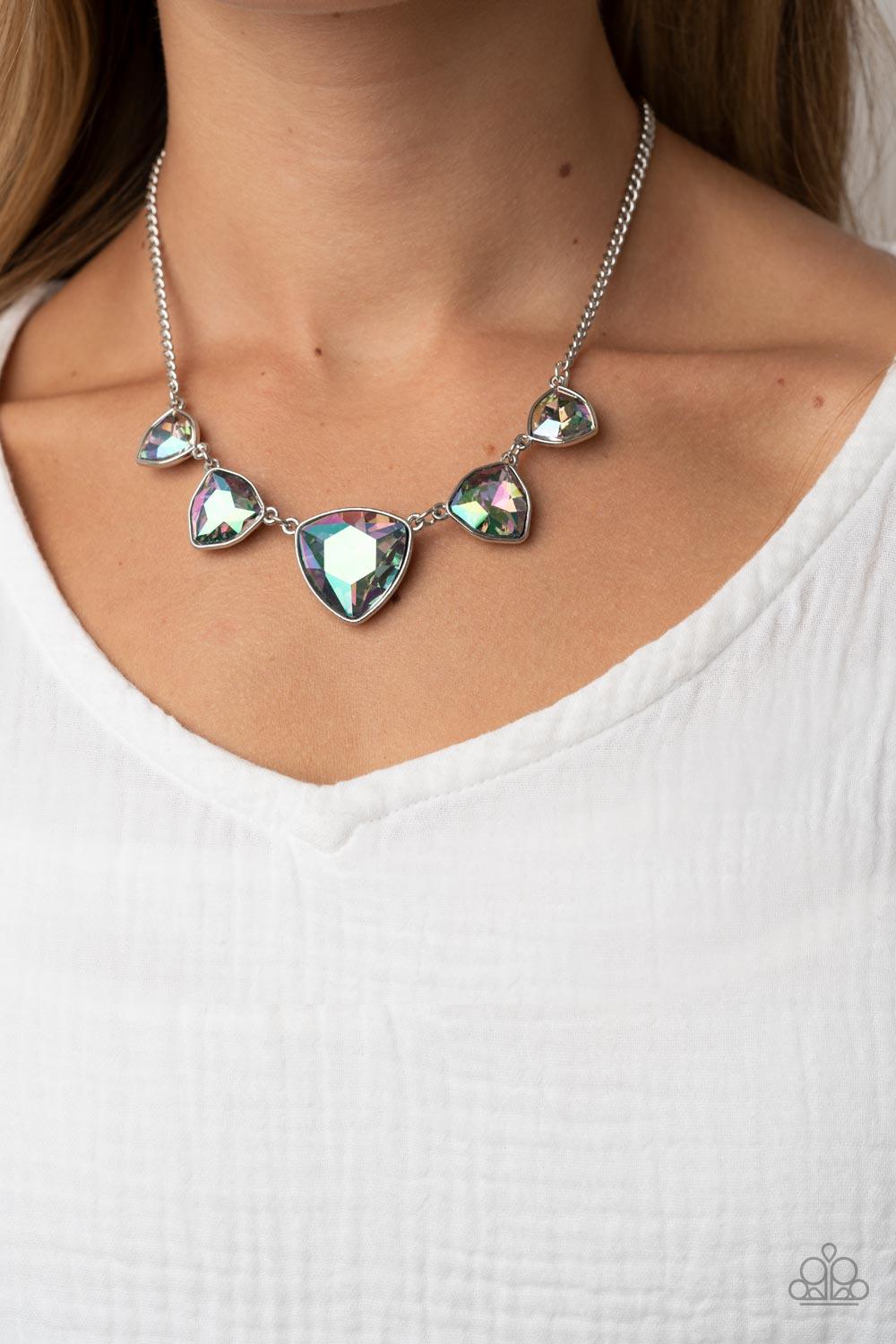 Paparazzi Accessories Cosmic Constellations - Multi Encased in sleek silver fittings, an oversized collection of UV geometric gems gradually increase in size as they link below the collar for a stellar statement. Features an adjustable clasp closure. Due