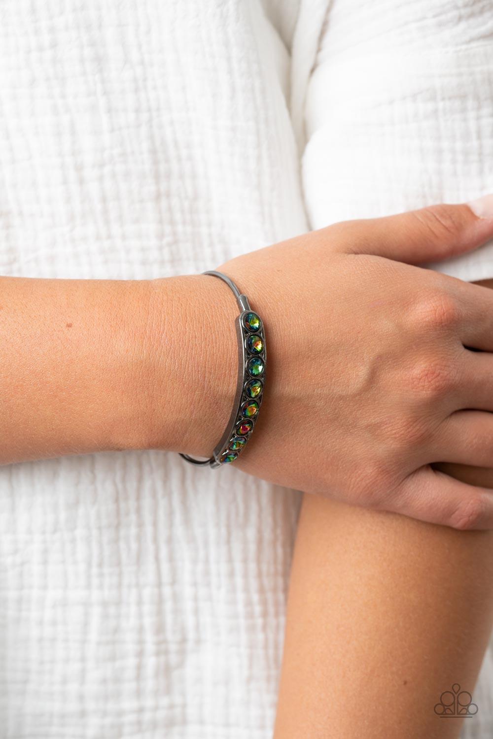 Paparazzi Accessories Vertigo Views - Multi A frame of oversized oil spill rhinestones is set atop a dainty gunmetal cuff featuring gunmetal beaded fittings, resulting in a stellar and stackable centerpiece. Sold as one individual bracelet. Jewelry