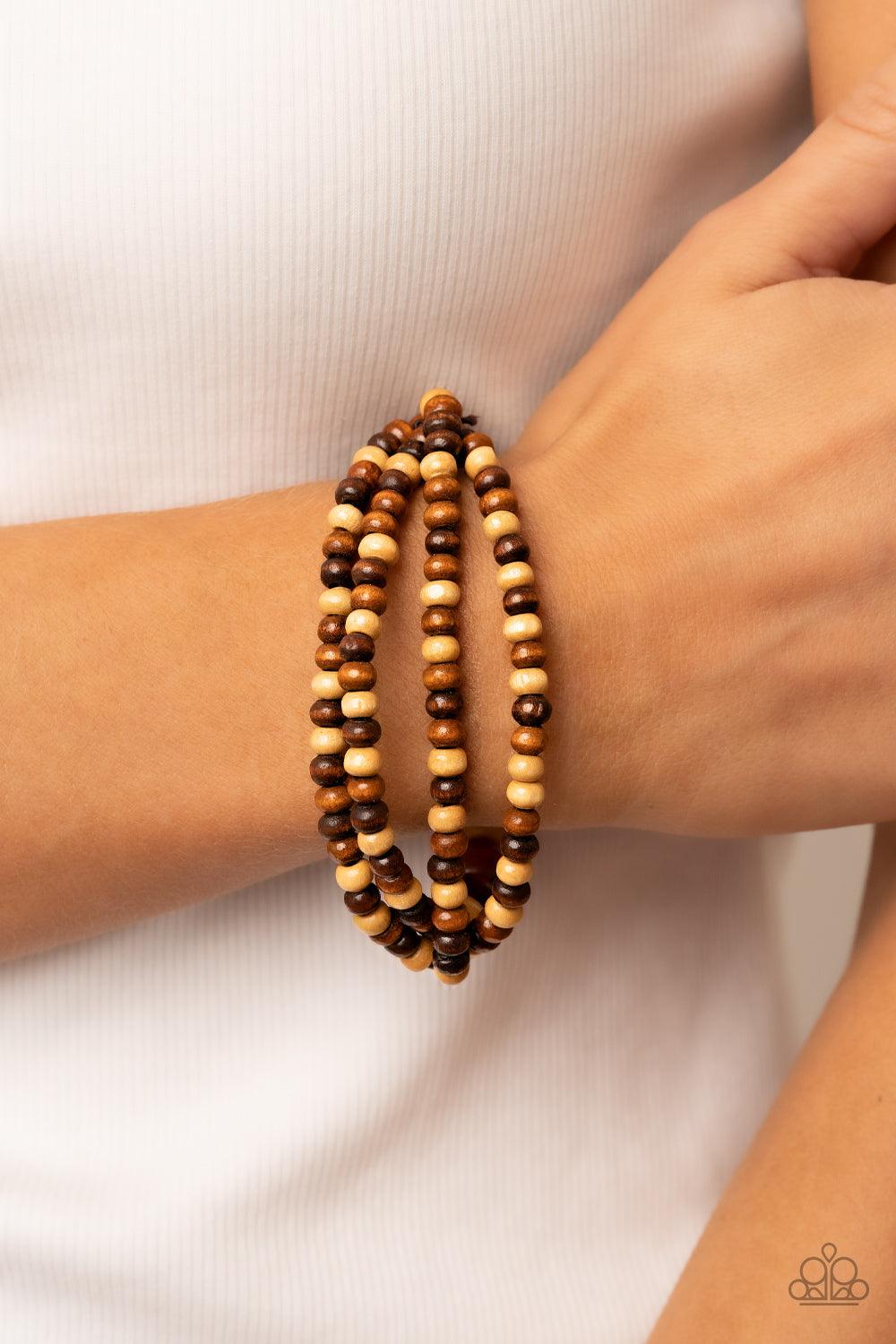 Paparazzi Accessories Oceania Oasis - Brown Varying in natural wooden finishes, stretchy strands of dainty wooden beads attach to a single row of oversized wooden beads around the wrist for an earthy spin on the homespun trend. Sold as one individual brac