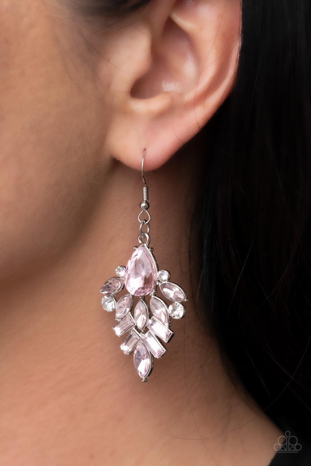 Paparazzi Accessories Stellar-escent Elegance - Pink Dainty white rhinestones are sprinkled between a stunning stack of emerald, teardrop, and marquise cut pink rhinestones, resulting in a lavish lure. Earring attaches to a standard fishhook fitting. Sold