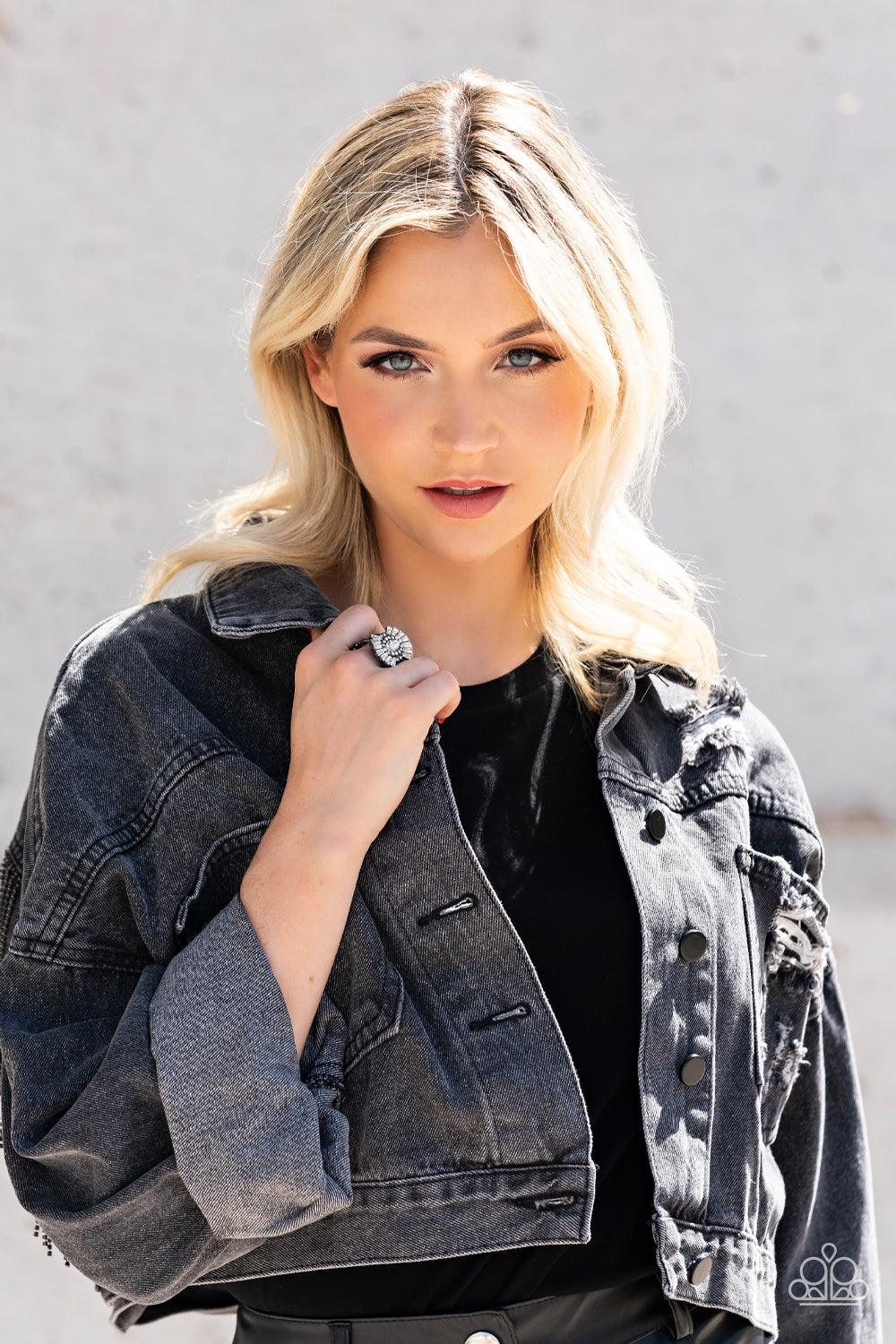 Paparazzi Accessories Daringly Deco - Black A white, marquise-cut rhinestone is bordered in glassy white rhinestones atop fans of trapezoidal-cut white rhinestones, resulting in an edgy sparkle that explodes atop the finger. Features a stretchy band for a