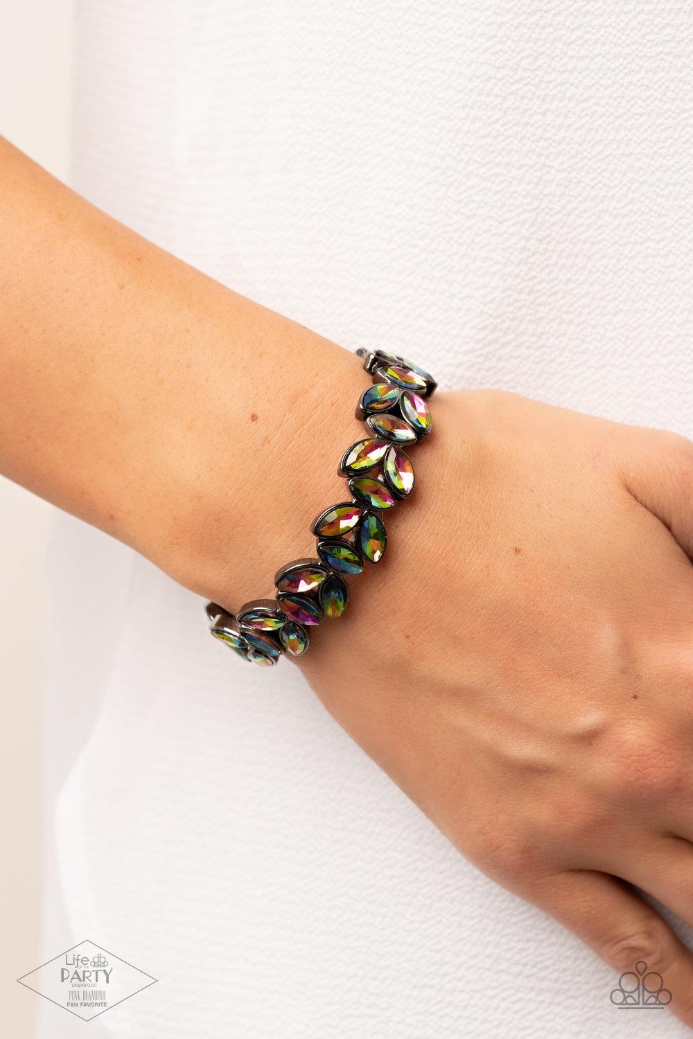 Paparazzi Accessories Gilded Gardens - Multi Featuring a stellar oil spill finish, trios of marquise cut rhinestones delicately join into leafy gunmetal frames along a stretchy band, creating a refined display around the wrist. Sold as one individual brac