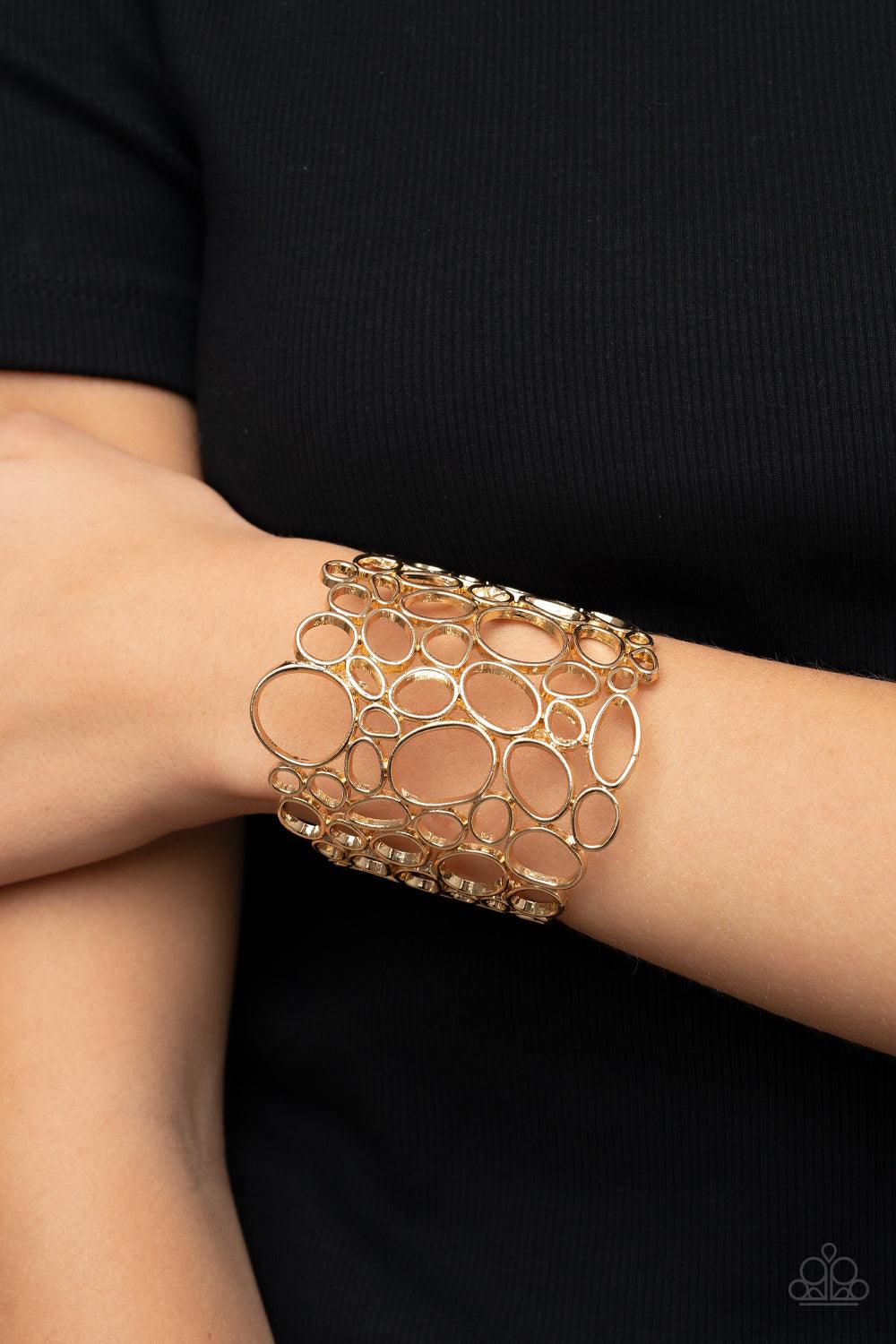 Paparazzi Accessories All Turned Around - Gold Varying in shape and size, asymmetrical gold circular frames delicately connect into an effervescently abstract cuff around the wrist. Sold as one individual bracelet. Jewelry