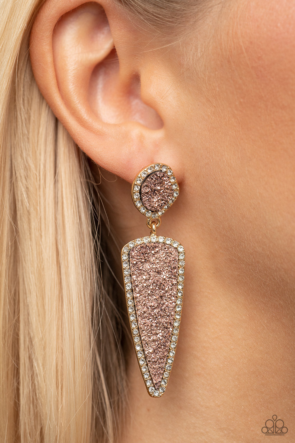Paparazzi Accessories Druzy Desire - Gold Featuring asymmetrical and triangular cuts, a pair of pink druzy-like accents are encased inside white rhinestone dotted gold frames as they link into a jaw-dropping lure. Earring attaches to a standard post fitti