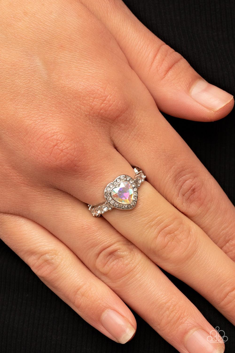 Paparazzi Accessories Romantic Reputation - Multi Bordered in a glassy frame of dainty white rhinestones, an iridescent heart shaped gem sparkles atop a silver band dotted in brilliant white rhinestones for a romantic finish. Features a dainty stretchy ba