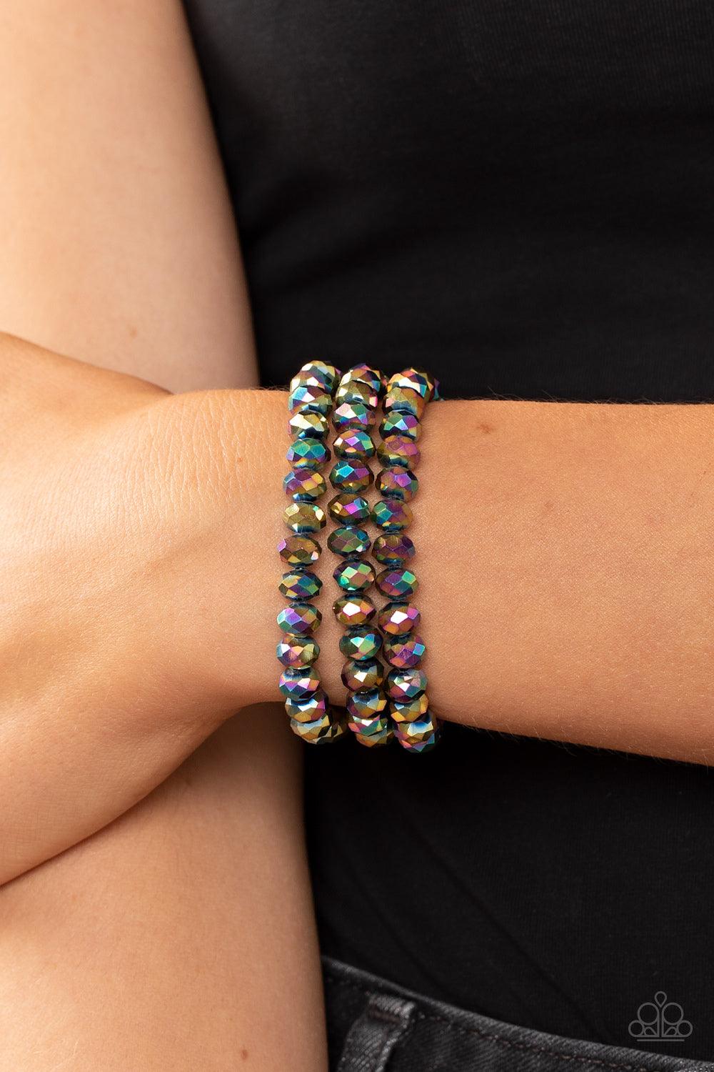 Paparazzi Accessories Supernova Sultry - Multi Rows of oil spill crystal-like beads are threaded along invisible wires around the wrist, layering into a smoldering sparkle. Features a magnetic closure. Sold as one individual bracelet. Jewelry