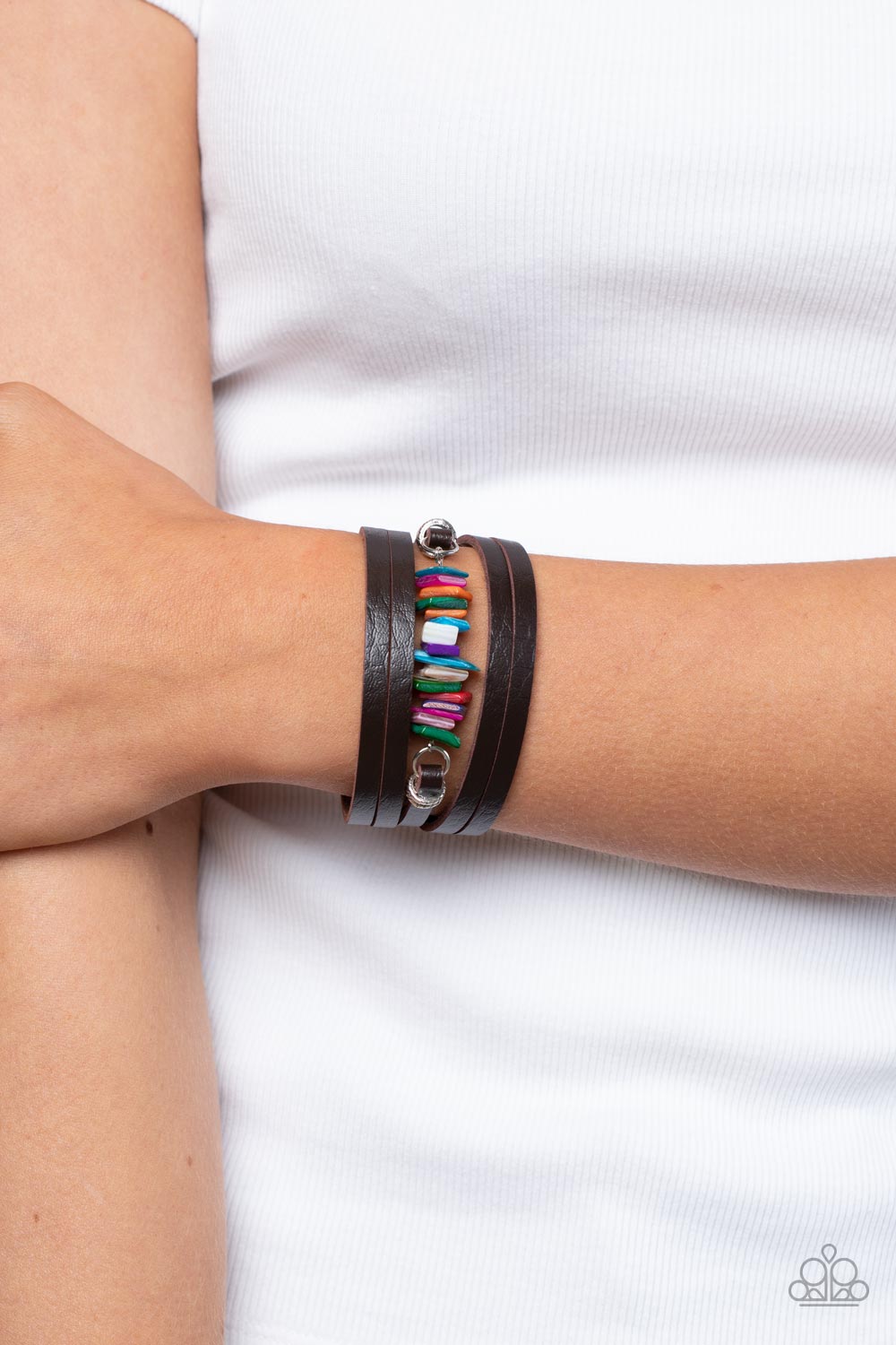 Paparazzi Accessories Tropical Trek - Multi A brown leather band is spliced into rugged layers around the wrist. Infused with textured silver rings, the centermost strand is infused with a stack of multicolored shell-like accents for a tropical inspired f
