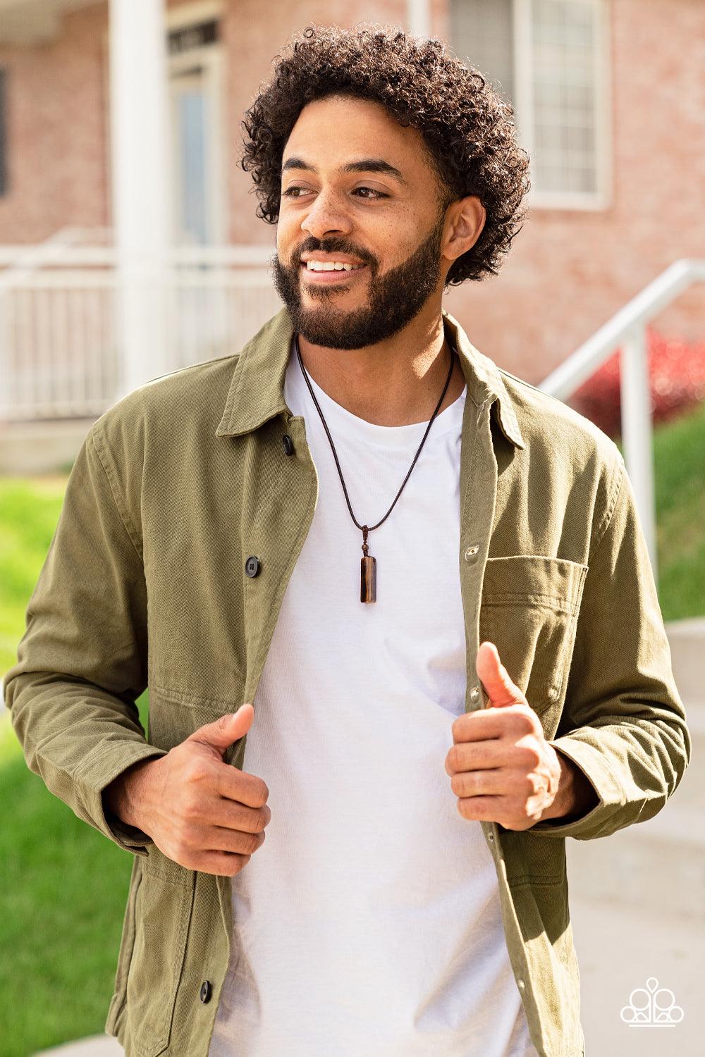 Paparazzi Accessories Comes Back ZEN-fold - Brown A rectangular tiger's eye stone pendulum is knotted in place below a dainty tiger's eye stone bead that glides along a shiny brown cord below the collar, resulting in an earthy pendant. Features an adjusta