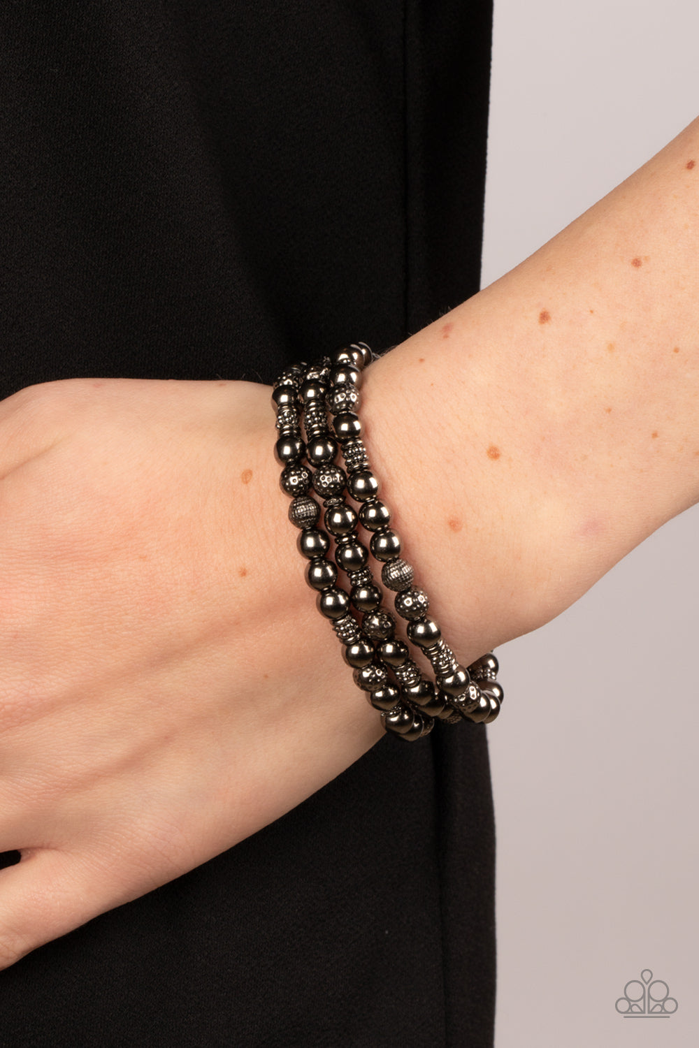 Paparazzi Accessories Boundless Boundaries - Black A gritty collection of smooth, studded, and textured gunmetal beads are threaded along stretchy bands around the wrist, creating dainty layers. Sold as one set of three bracelets. Jewelry