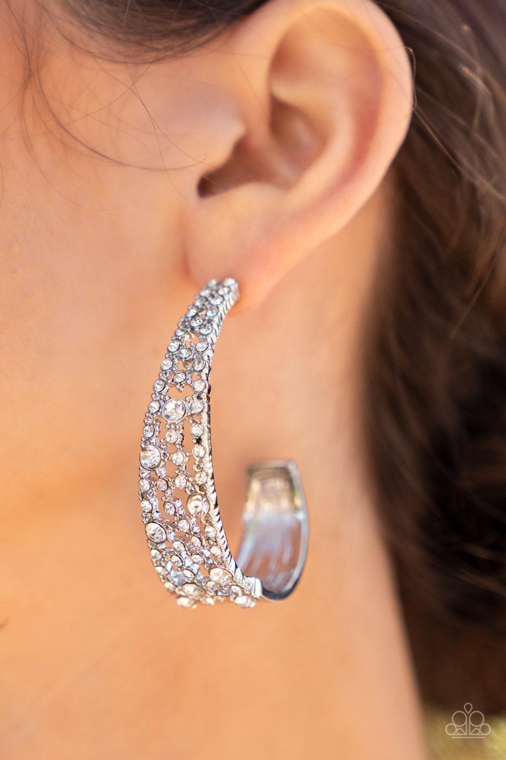Paparazzi Accessories Cold as Ice - White Classic white rhinestones dot a silvery backdrop of dainty white rhinestones that delicately curves into a solid silver J-hoop, resulting in a jaw-dropping dazzle. Earring attaches to a standard post fitting. Hoop